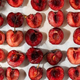 Cherries halved sitting on baking sheet for roasting